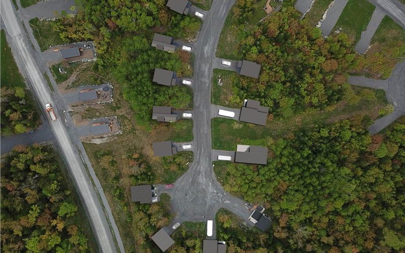 Aerial view of EcoCoves chalets among trees in Adstock